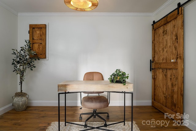 office featuring a barn door, ornamental molding, and wood finished floors