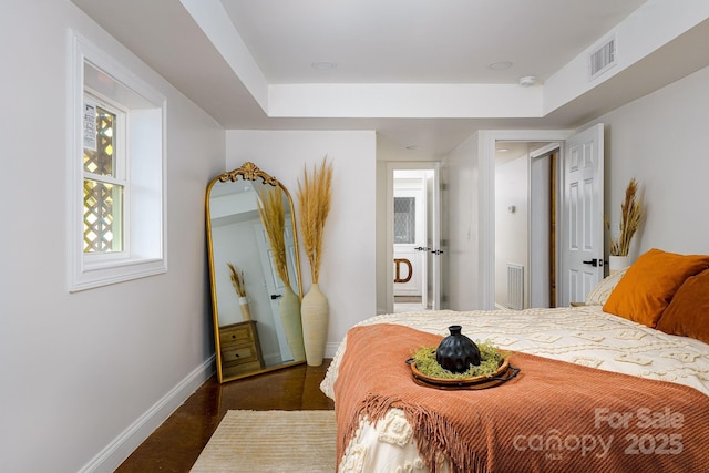 bedroom featuring visible vents and baseboards