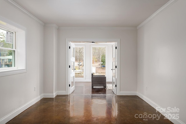 doorway with concrete floors, baseboards, and ornamental molding