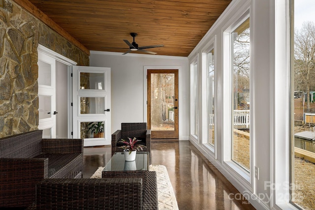 sunroom with a ceiling fan and wooden ceiling