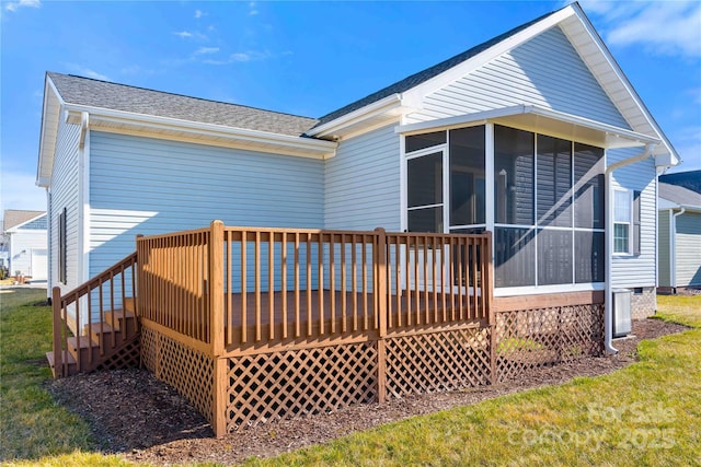 357 Beechnut Dr, Hendersonville, NC 28739 - rear view of house with a sunroom, a shingled roof, a deck, and a lawn