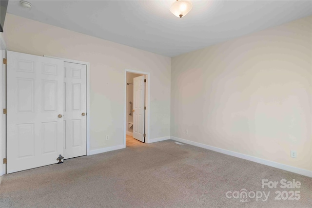 357 Beechnut Dr, Hendersonville, NC 28739 - unfurnished bedroom featuring carpet, connected bathroom, and baseboards