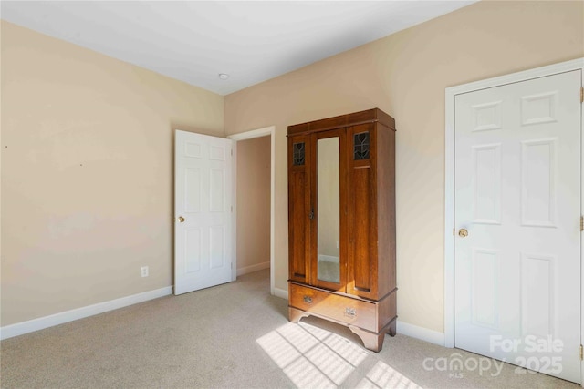 357 Beechnut Dr, Hendersonville, NC 28739 - unfurnished bedroom featuring baseboards and light colored carpet