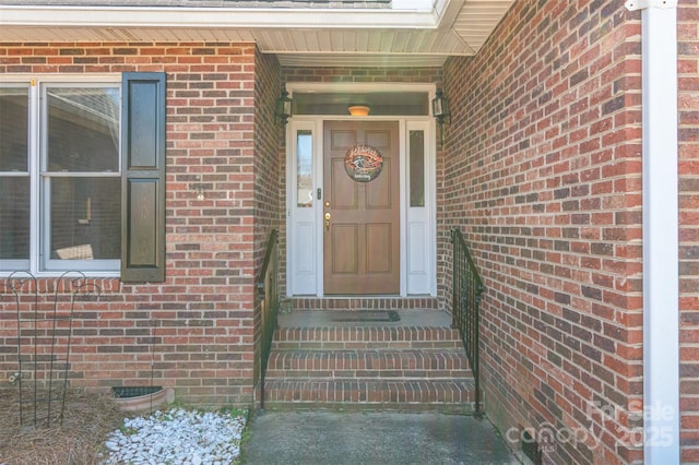 property entrance with brick siding