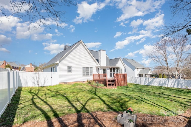 rear view of property with crawl space, a wooden deck, a lawn, and a fenced backyard