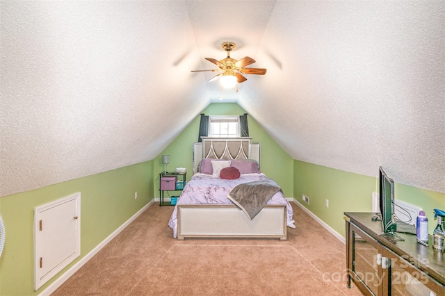 carpeted bedroom with vaulted ceiling, baseboards, and a textured ceiling