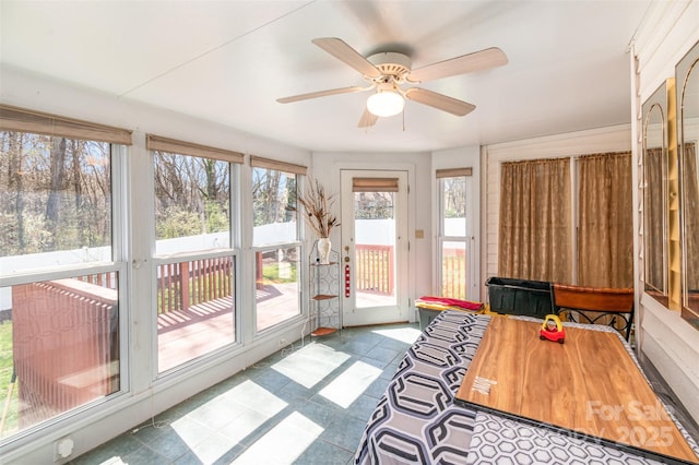 sunroom / solarium featuring ceiling fan