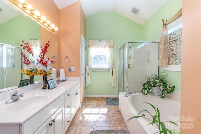 full bath featuring double vanity, a shower stall, lofted ceiling, and a sink