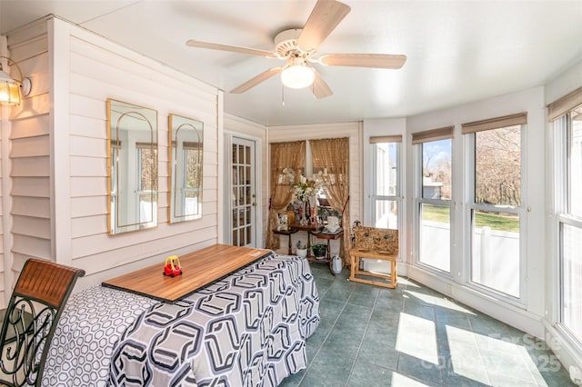 sunroom featuring ceiling fan