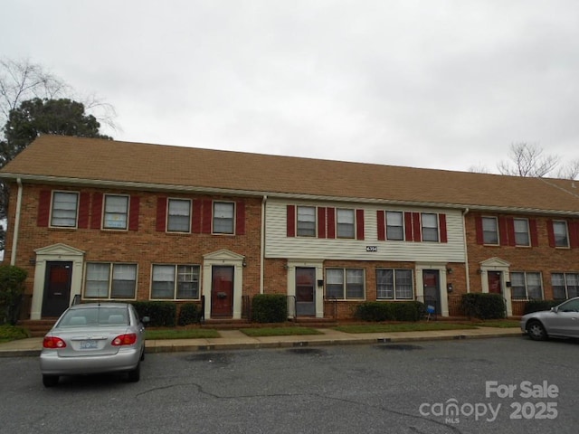 view of property featuring brick siding