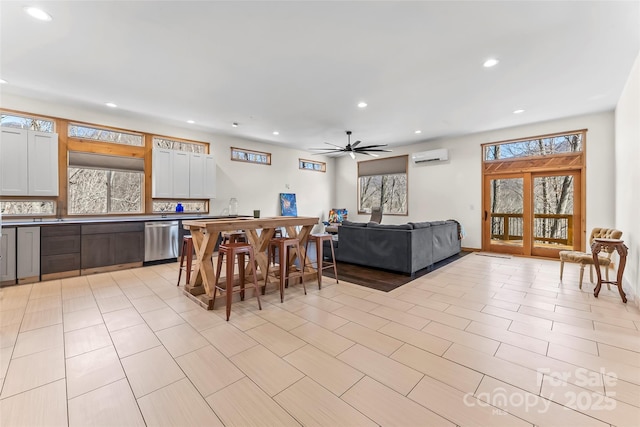 dining space featuring plenty of natural light, recessed lighting, an AC wall unit, and ceiling fan