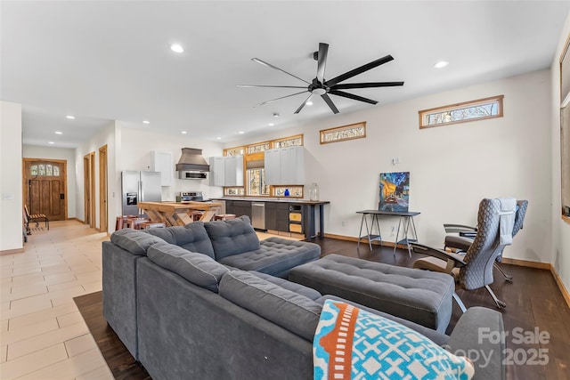 living room with recessed lighting, a ceiling fan, and baseboards