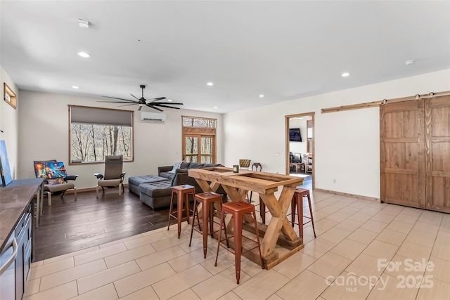 dining area featuring recessed lighting, baseboards, a barn door, and a ceiling fan