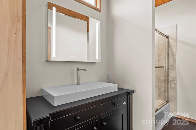 bathroom with vanity and shower / bath combination with glass door