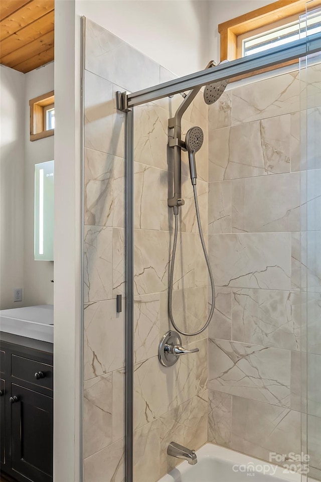 full bathroom featuring combined bath / shower with glass door and a healthy amount of sunlight