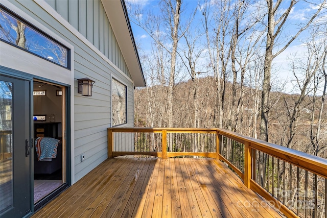 wooden deck with a view of trees