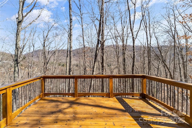 wooden terrace with a view of trees