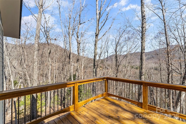 wooden terrace with a wooded view