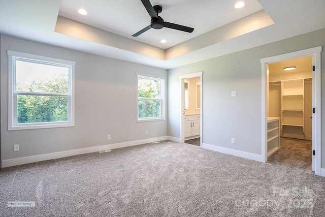1906 Maius Dr, Conover, NC 28613 - unfurnished bedroom with a raised ceiling, a walk in closet, baseboards, carpet flooring, and recessed lighting
