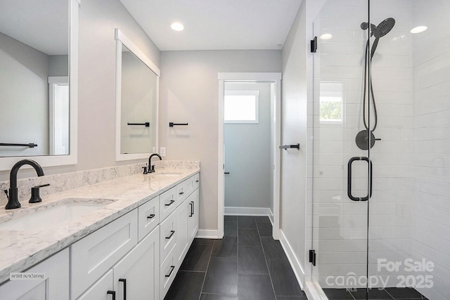 1906 Maius Dr, Conover, NC 28613 - bathroom with a stall shower, baseboards, and double vanity
