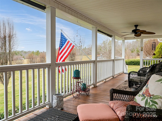 wooden terrace with a ceiling fan