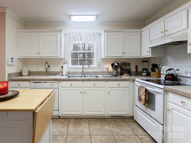 kitchen featuring ornamental molding, a sink, wood counters, under cabinet range hood, and white appliances