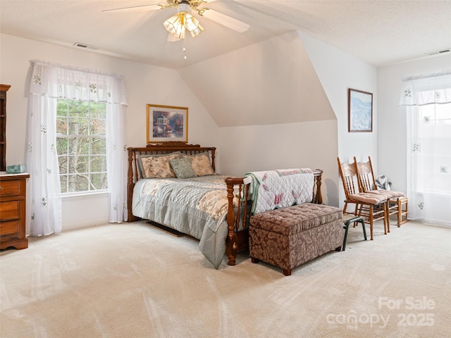 bedroom with lofted ceiling, visible vents, carpet floors, and ceiling fan