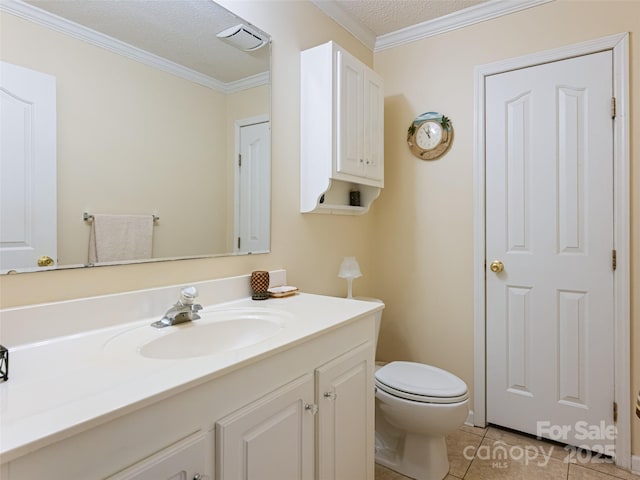 bathroom with toilet, a textured ceiling, crown molding, tile patterned flooring, and vanity