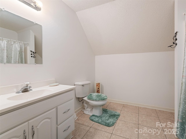 full bathroom featuring vanity, lofted ceiling, tile patterned flooring, a textured ceiling, and toilet