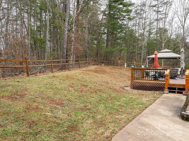 view of yard with a deck, a gazebo, and a fenced backyard