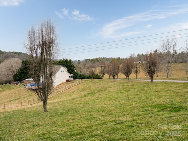 view of yard featuring a rural view and fence