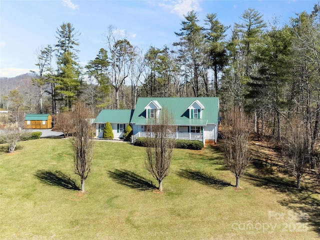 view of front of property with covered porch and a front yard