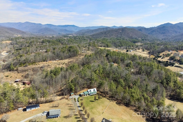 aerial view with a wooded view and a mountain view