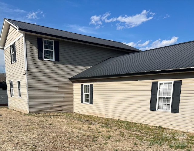 view of side of property featuring metal roof