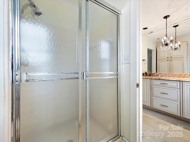 bathroom featuring a stall shower, crown molding, and vanity