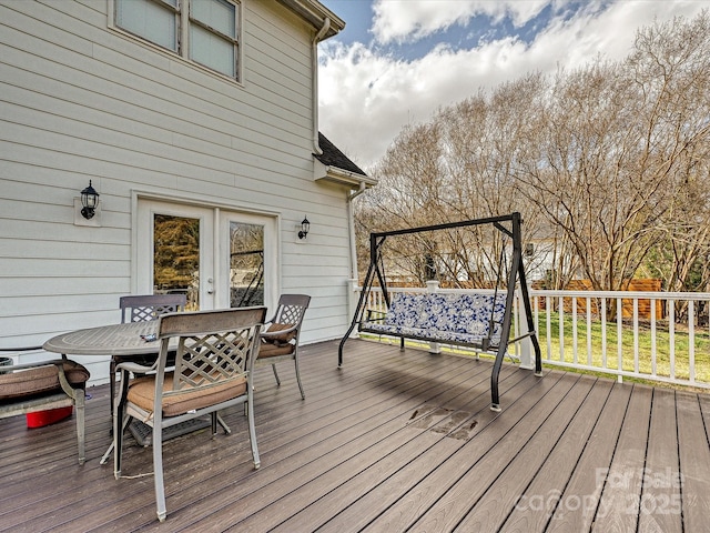 wooden terrace featuring outdoor dining area