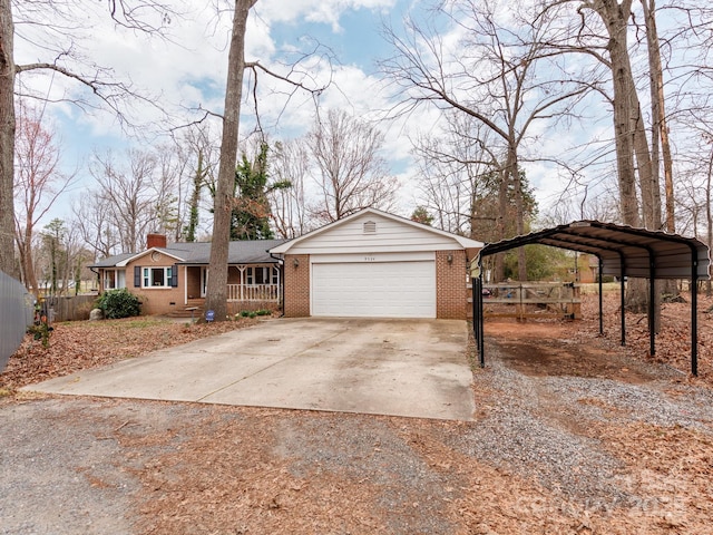 view of front of home featuring driveway, a garage, a chimney, fence, and brick siding