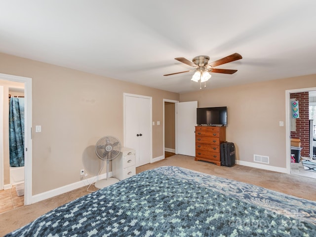 carpeted bedroom with a ceiling fan, visible vents, and baseboards