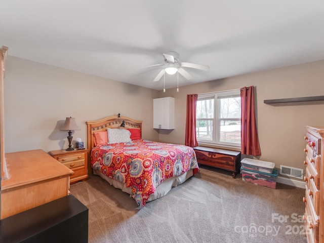 bedroom with a ceiling fan, visible vents, and light carpet