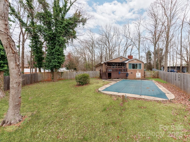 view of pool with a lawn, a fenced backyard, a wooden deck, and a fenced in pool