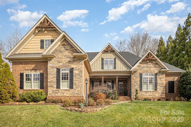 craftsman-style house featuring stone siding, board and batten siding, and a front yard