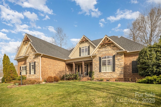 craftsman inspired home with roof with shingles, board and batten siding, and a front lawn