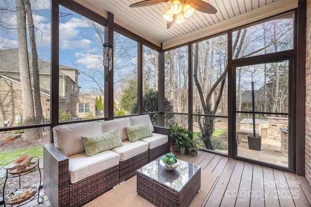 sunroom with wooden ceiling and ceiling fan