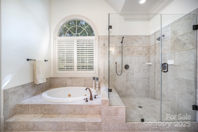 full bathroom with a shower stall, a jetted tub, and crown molding