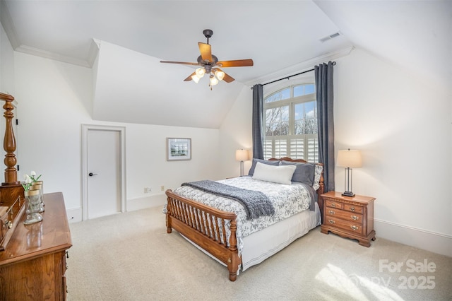 bedroom featuring visible vents, baseboards, light colored carpet, and vaulted ceiling