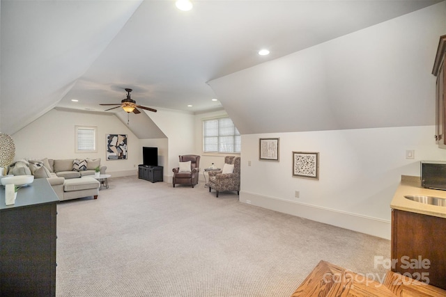 living area featuring vaulted ceiling, recessed lighting, light colored carpet, and baseboards