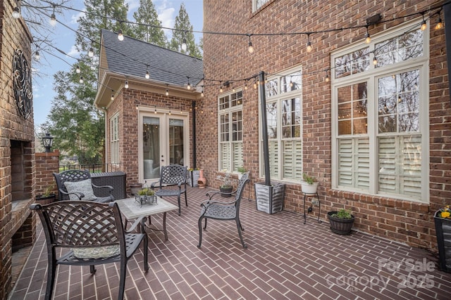 view of patio with a brick fireplace and french doors