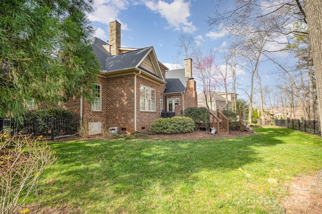 view of side of home with brick siding, fence, roof with shingles, a lawn, and a chimney