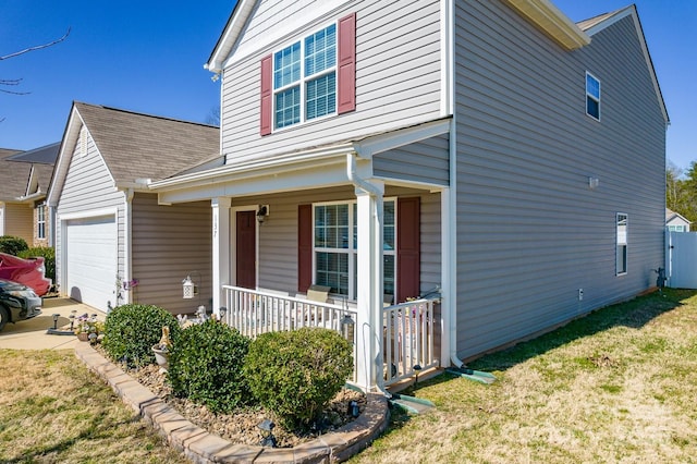 view of property exterior featuring a yard, a porch, and an attached garage