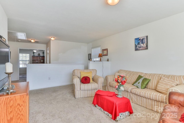 living room featuring carpet and attic access